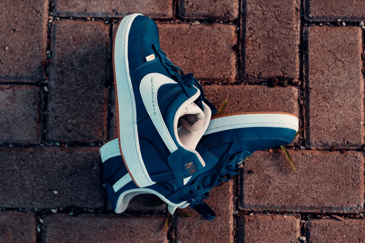 Services Close-up of blue sneakers on a brick pavement, highlighting urban street style in Maracanaú, Brazil.